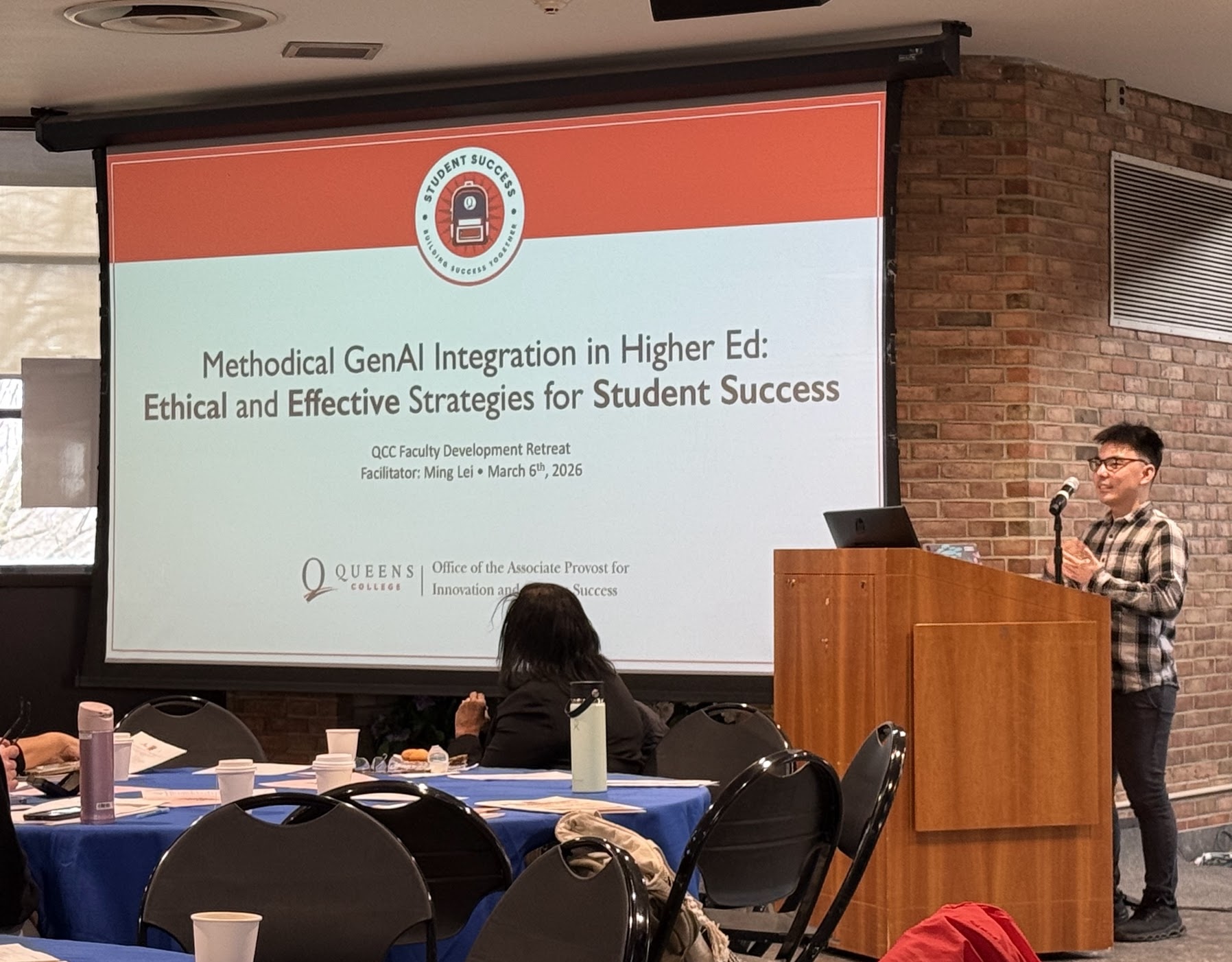 Ming standing in front of his presentation at QCC Faculty Development Retreat